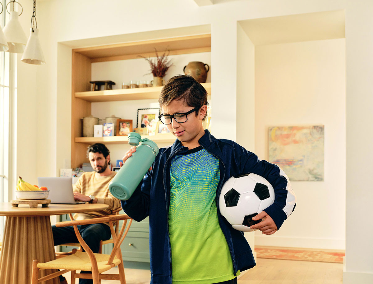 Young boy grimacing at water bottle